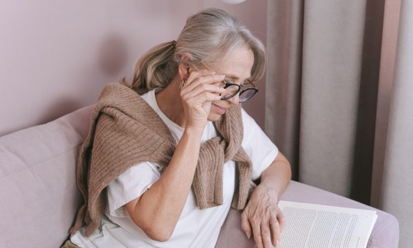 Photo of an Elderly Woman with Gray Hair Reading a Book